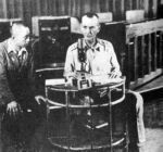Major General Jonathan M. (Skinny) Wainwright at the microphone of radio station KZRH in Manila, ordering that US and Filipino troops in all the Philippine Islands lay down their arms and surrender to the nearest Japanese garrison. Note the Japanese interpreter listening to Wainwright's right.